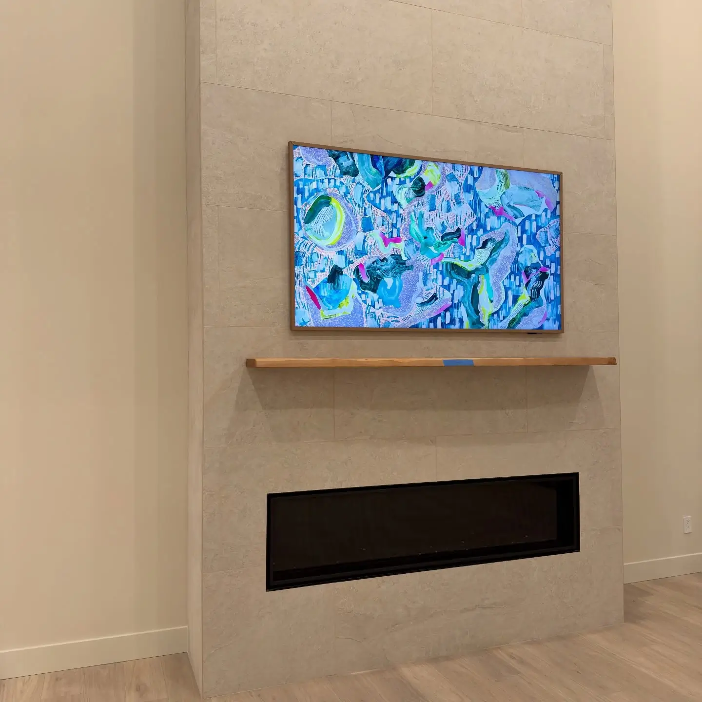 Samsung Frame TV mounted on tiled fireplace wall