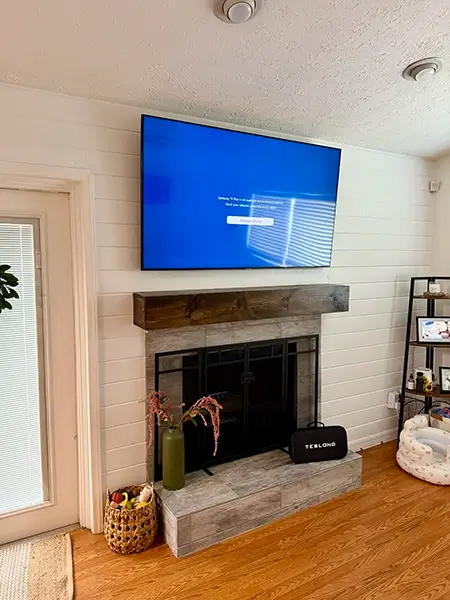 TV mounted above a fireplace